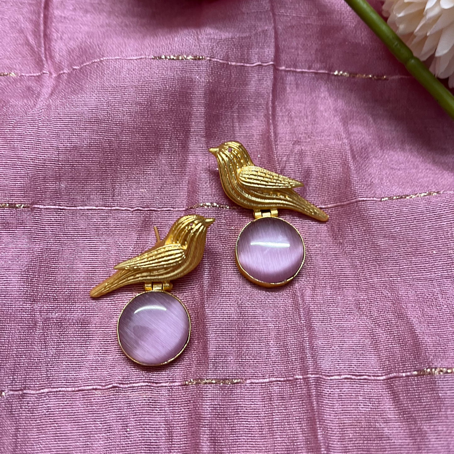 Golden bird with purple stone