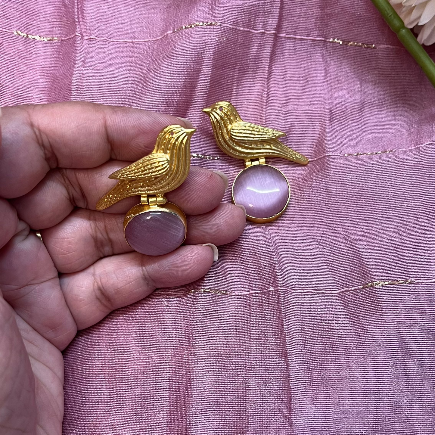 Golden bird with purple stone